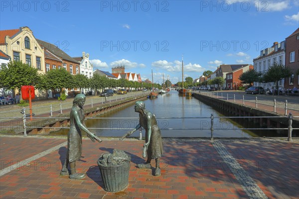 Old harbour with the bronze sculpture 'Törfwieven' in Weener, East Frisia, Lower Saxony, Germany, Europe
