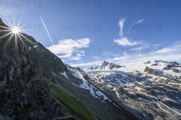 High alpine mountain landscape with sun star, summit of Aiguille de Chardonnet and Glacier du Tour, glacier and mountain peaks, Chamonix, Haute-Savoie, France, Europe