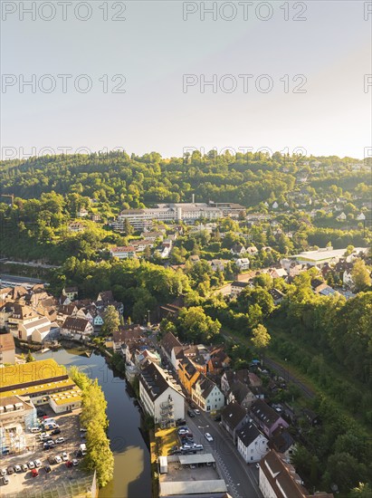 Hospital with city view from the air along a river, surrounded by hilly forests and roads, Calw, Black Forest, Germany, Europe
