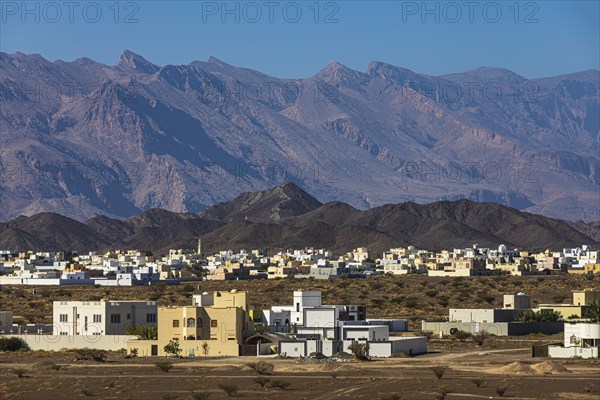 The new settlement of Jabrin, view from the palace fortress of Jabrin, behind the mountains of Jebel Akhdar, near the city of Bahla, Arabian Peninsula, Sultanate of Oman