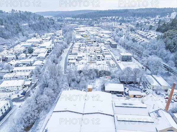 Snow-covered area with factory and housing estate in a hilly landscape, Nagold, Black Forest, Germany, Europe