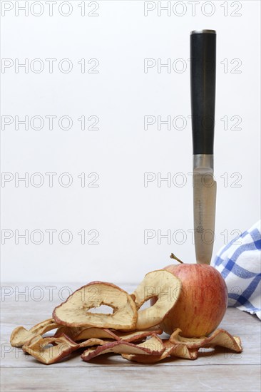 Apple with knife and apple rings, dried fruit