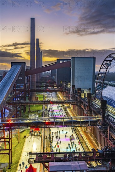 The ice rink at the Zollverein coking plant, UNESCO World Heritage Zollverein Coal Mine Industrial Complex, 150 metres long, against the backdrop of the coke ovens, formerly the largest coking plant in the world, Essen, North Rhine-Westphalia, Germany, Europe
