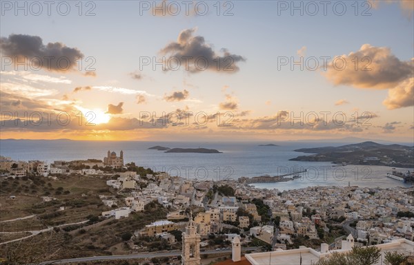 View from Ano Syros to the houses of Ermoupoli with the Anastasi Church or Church of the Resurrection, town view with islands and sea, dramatic cloudy sky at sunrise, Ano Syros, Syros, Cyclades, Greece, Europe