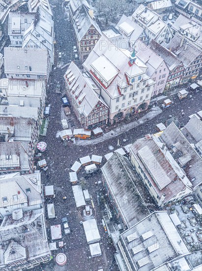 Winter drone shot of a snowy urban scenery with recognisable streets and roofs, Black Forest, Calw, Germany, Europe