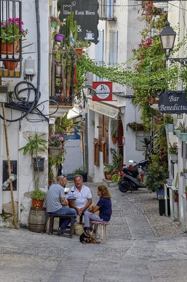 People in a sidewalk café in the old town of Peñíscola, Castellón province, Costa del Azahar, Valencia region, Spain, Europe
