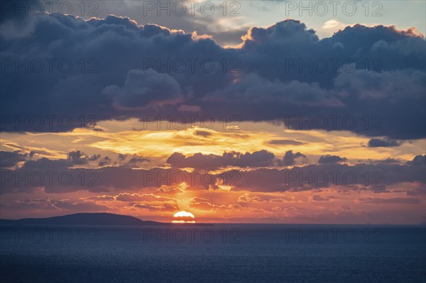 Dramatic cloudy sky at sunrise over the sea, Aegean Sea, Syros, Cyclades, Greece, Europe
