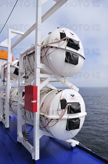 Inflatable life rafts in hard-shell canisters on board a ferry boat