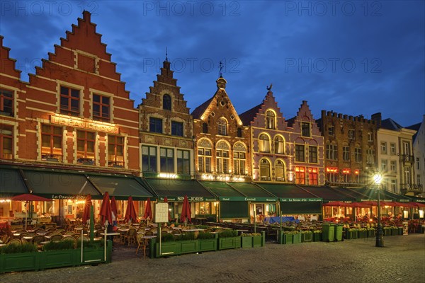 Bruges, Belgium, May 29, 2018: Bruges Grote markt square famous tourist place with many cafe and restaurants in the evening night twilight, Europe