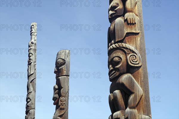Giant wooden totems, faces, art of the indigenous peoples of Canada, Stewart Cassiar Highway, British Columbia, Canada, North America
