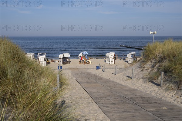 Path made of wooden boards between the dunes, beach chairs on the sandy beach, Loddin, Usedom Island, Baltic Sea, Mecklenburg-Western Pomerania, Germany, Europe