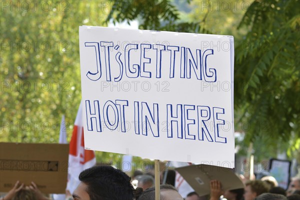 Heidelberg, Germany, September 2019: Protest sign cardboard saying Its getting hot in here during Fridays for Future strike for the climate, Europe