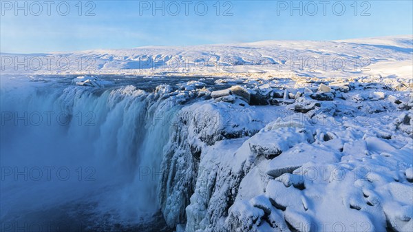 Godafoss waterfall in first morning sun, snow-covered landscape, Northern Iceland Eyestra, Iceland, Europe