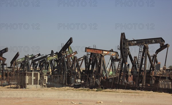Storage with disused oil pumps near Marmul, Oman, Asia