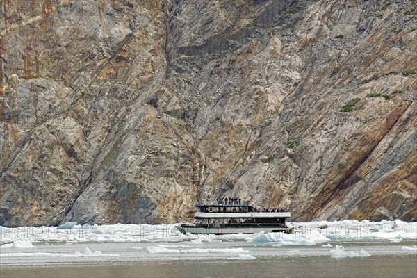 Small boat between ice of a glacier calving into the sea, Tracy Arm Fiord, Tongass National Forest, Juneau, Inside Passage, Alaska, USA, North America