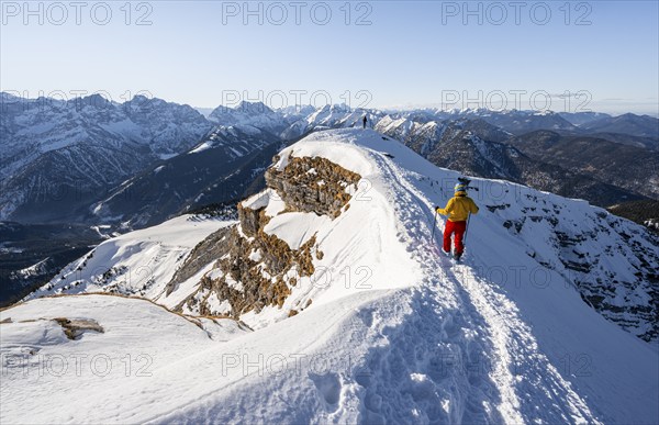 Two ski tourers at the summit of Schafreuter, view of snowy mountain panorama, Karwendel, Tyrol, Austria, Europe
