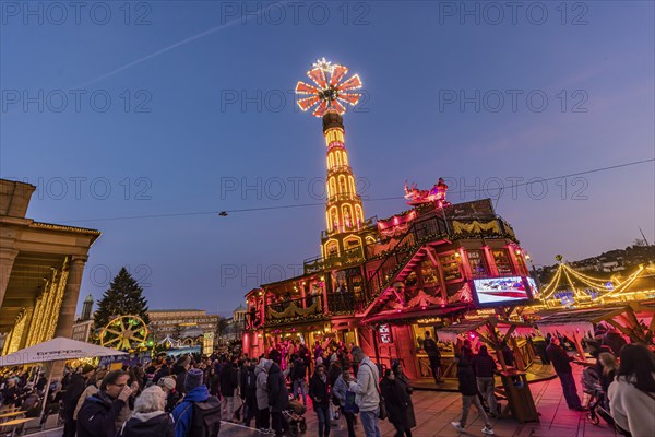 Stuttgart Christmas market at the blue hour. Christmas pyramid on the Schlossplatz in front of the Königsbau. The traditional event attracts more than three and a half million people to the city centre during the Christmas season. Stuttgart, Baden-Württemberg, Germany, Europe