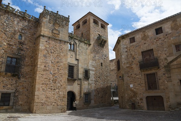 A historic stone building with a tower under a cloudy sky, palace, Palacio de los Golfinos de Abajo, local museum, old town, Cáceres, Caceres, Extremadura, Spain, Europe