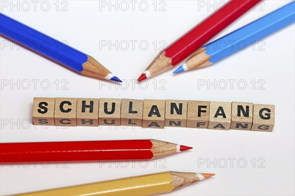 Symbolic image for the start of the new school year with letter cubes and pens