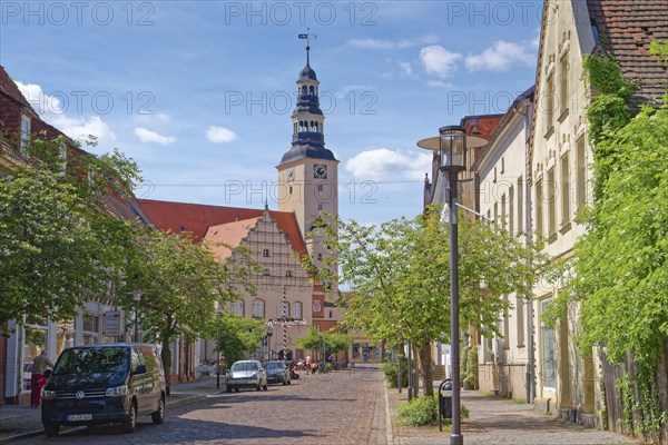 Residential and commercial buildings in Rudolf-Breitscheid-Straße, paved with cobblestones, in the old town centre of Gardelegen in the Altmark, with the town hall in the background. Hanseatic town of Gardelegen, Saxony-Anhalt, Germany, Europe