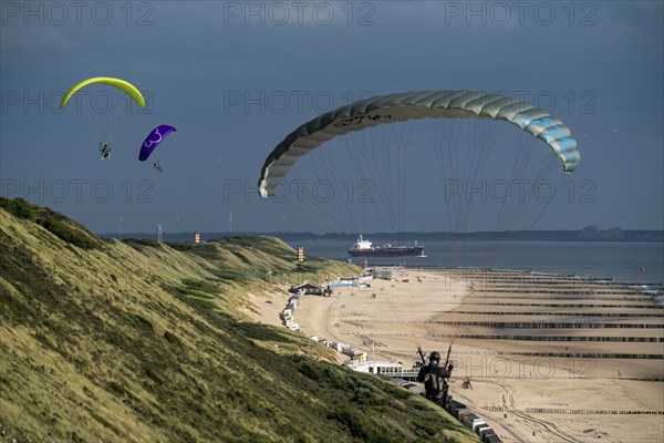 Paragliders along the dunes of Zoutelande, in Zeeland, South Holland, Netherlands