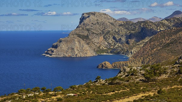 Rocky coastal landscape above a deep blue sea under a clear sky, Mesochori village, west coast, Karpathos, Dodecanese, Greek Islands, Greece, Europe