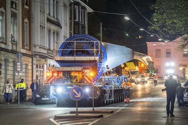 Transport of a 68 metre long, 22 tonne blade of a wind turbine, here in Schwelm, with a self-propelled Blade-Lifter vehicle, over a 40 km long route, over 2 nights, in the Bergisches Land, through towns, villages, over country roads, narrow through roads, to the construction site of the wind turbine near Hagen, North Rhine-Westphalia, Germany, Europe