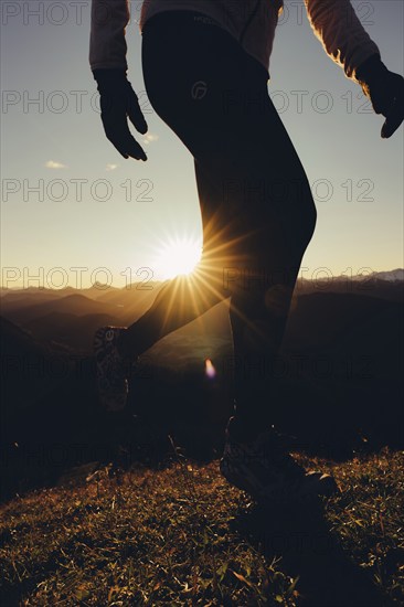 Trail running in autumn on the Jochberg on Lake Walchensee against the wonderful backdrop of the Alps, Bavaria, Germany, Europe