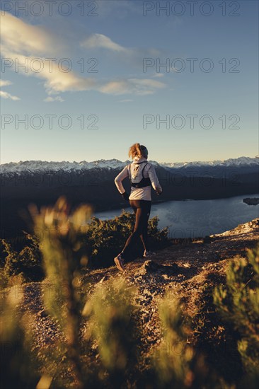 Trail running in autumn on the Jochberg on Lake Walchensee against the wonderful backdrop of the Alps, Bavaria, Germany, Europe