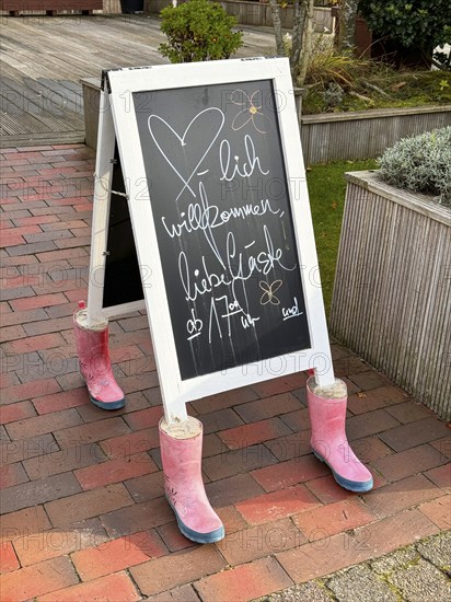 Table of a restaurant, weighted down with rubber boots filled with concrete, North Sea island of Spiekeroog, East Frisia, Lower Saxony, Germany, Europe