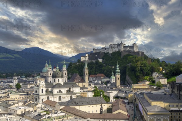 Panorama of Salzburg's historic city centre at dusk with Hohensalzburg Fortress and dramatic clouds, Salzburg, Salzburger Land, Austria, Europe