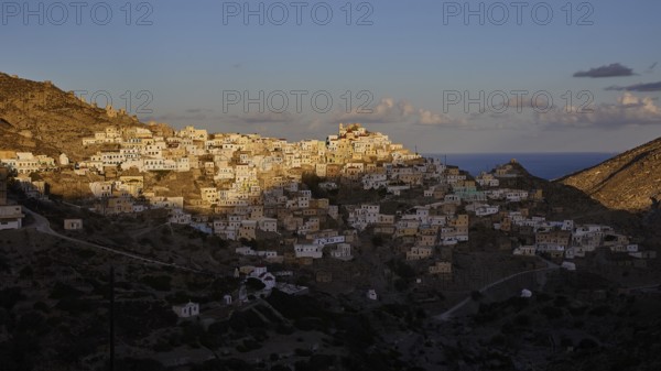 Hilltop town overlooking the sea in the golden morning light, Colourful mountain village, Morning light, Olymbos, Karpathos, Dodecanese, Greek Islands, Greece, Europe
