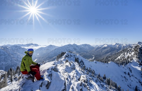 Ski tourer at the summit of the Teufelstättkopf, snowy mountain landscape, Sonnenstern, mountain panorama, Ammergau Alps, Bavaria, Germany, Europe