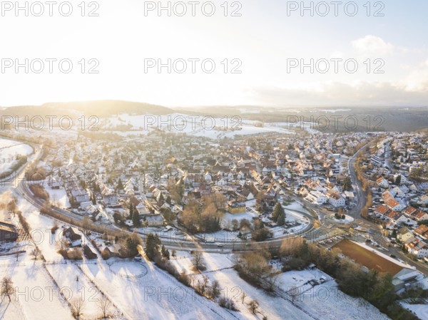 Snow-covered village in a vast landscape with low sun, Calw- Stammheim, Black Forest, Germany, Europe