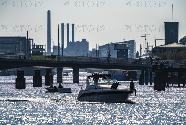 View over the harbour, the pedestrian and cycle bridge Inderhavnsbroen, skyline at Sydhavnen in the background, chimneys of the combined heat and power plant H.C. Ørstedsværket, Copenhagen, Denmark, Europe