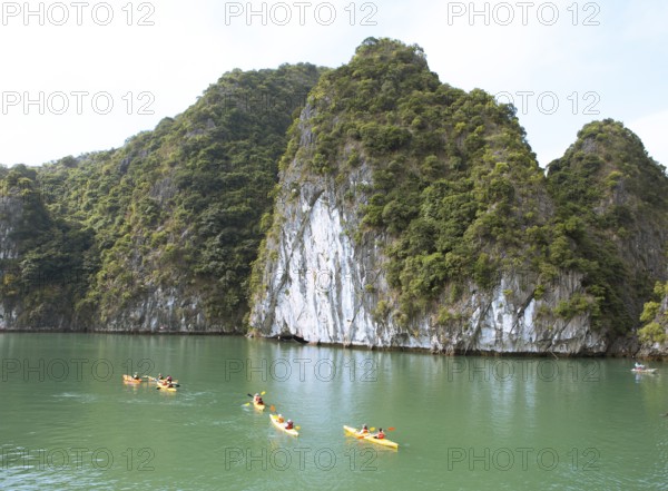 Kayakers and the karst rocks in Lan Ha Bay, Halong Bay, Vietnam, Asia