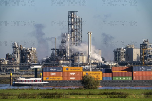Cargo ship on the Rhine near Emmerich, Kao Chemicals backdrop, specialising in surfactants, KLK, Left Rhine pastures, Lower Rhine, North Rhine-Westphalia, Germany, Europe