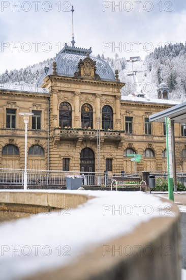 An imposing historic building in winter, surrounded by snow and wooded hills, König-Karls-Bad, Bad Wildbad, Black Forest, Germany, Europe