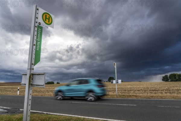 Single stop of bus line 510 between Korbach and Bad Wildungen, country road near Waldeck in North Hesse, bus stop Abzweig Netze, bus traffic between 6 a.m. and 5 p.m., NVV, Nordhessische VerkehrsVerbund, thunderstorm front approaching, Germany, Europe