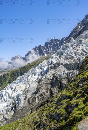 Glacier ice of the Glacier des Bossons, behind pointed mountain peaks, Chamonix, Haute-Savoie, France, Europe