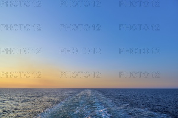 View from the cruise ship at sunset at the stern of the ship onto the stern waves, North Sea, Denmark, Europe
