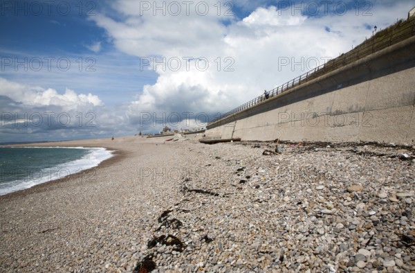 Shingle beach and large sea wall providing coastal defence at Chiswell, Isle of Portland, Dorset, England, UK