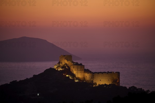 Illuminated castle ruins at dusk with a view of the sea and the surrounding mountains, Kritinia Castle, St John's Castle, Kritinia, Rhodes, Dodecanese, Greek Islands, Greece, Europe