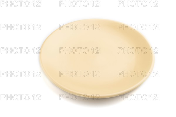 Empty beige ceramic plate isolated on white background. Side view, close up