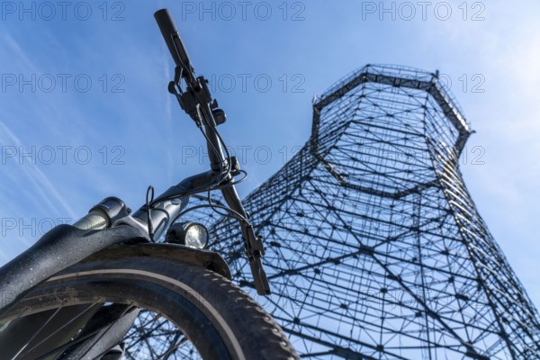 Cycling in the Ruhr area, at the Zollverein Coal Mine Industrial Complex World Heritage Site, lattice cooling towers on the coking plant site, Essen, North Rhine-Westphalia, Germany, Europe