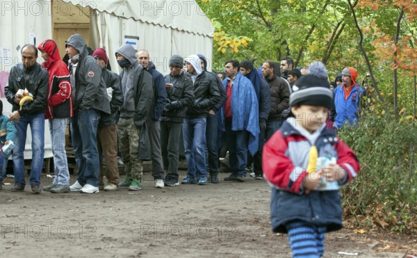 Refugees from Syria waiting to be registered at the Central Reception Centre for Asylum Seekers at the Berlin State Office for Health and Social Affairs, queue at the food counter, 09/10/2015