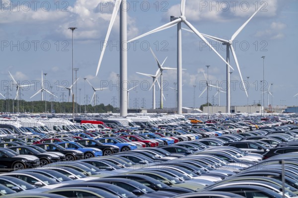 Storage area for new cars in the port of Vlissingen-Oost, vehicles are temporarily stored on over 100 hectares to ship them from Europe to the United Kingdom, Ford cars, others such as models from the Chinese car manufacturer BYD are delivered from here in Europe, wind farm, Netherlands