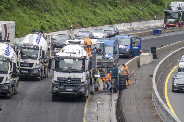 Motorway construction site on the A52 in Essen, basic renovation of the two carriageways in both directions, over 8 years, here the construction of concrete crash barriers between the carriageways, using the so-called sliding construction method, around 500 metres of concrete crash barrier, crash barrier is built per day, North Rhine-Westphalia, Essen