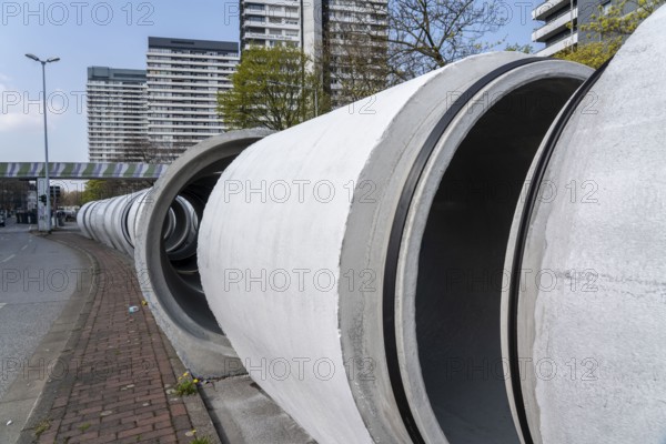 Concrete sewer pipes, stored on a construction site during sewer renovation work, on the Dickswall, city centre of Mülheim an der Ruhr, North Rhine-Westphalia, Germany, Europe