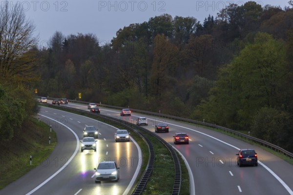 Traffic on a wet motorway at dusk, surrounded by trees, Rems-Murr district, Baden-Württemberg, Germany, Europe